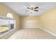 Expansive living room with tile floors, ceiling fan, and a large window providing natural light at 12802 Lake Vista Dr, Gibsonton, FL 33534