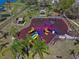 Aerial view of fenced in playground with mulch base, covered picnic tables and a variety of play equipment at 12802 Lake Vista Dr, Gibsonton, FL 33534