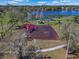 Aerial view of a colorful playground featuring slides and swings adjacent to a tranquil lake at 12802 Lake Vista Dr, Gibsonton, FL 33534
