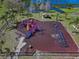 Aerial view of a colorful playground with swings and slides, offering a fun recreation area by the lake at 12802 Lake Vista Dr, Gibsonton, FL 33534