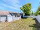 The home has a spacious backyard with a privacy fence, lush green grass, and a shed at 1528 W River Shore Way, Tampa, FL 33603