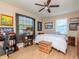 This bedroom features wood look floors, a bed with white comforter, and multiple shelving units at 1528 W River Shore Way, Tampa, FL 33603