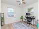 This bedroom features wood look flooring, two windows, and a desk and computer setup on a stylish rug at 1528 W River Shore Way, Tampa, FL 33603