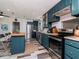 Open-concept kitchen features stainless steel appliances, an island, and ample cabinet space at 1528 W River Shore Way, Tampa, FL 33603