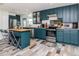 Bright kitchen featuring stainless steel appliances, kitchen island with seating, and stylish blue cabinets at 1528 W River Shore Way, Tampa, FL 33603