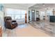 Relaxing living room area with a comfortable leather recliner and bright, sunny windows at 1528 W River Shore Way, Tampa, FL 33603