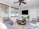 Modern living room with a large TV, comfortable seating, and ample natural light at 1528 W River Shore Way, Tampa, FL 33603