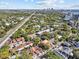 Wide aerial view of charming townhomes near highways with a city skyline in the distance at 2537 W Maryland Ave, Tampa, FL 33629