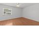 Bedroom featuring wood-look floors, a ceiling fan, and a window at 2537 W Maryland Ave, Tampa, FL 33629