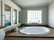 Bright bathroom featuring a garden tub, glass block window and built in storage at 272 S Port Royal Ln, Apollo Beach, FL 33572