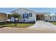 Charming single-story home with a well-maintained lawn and blue trim details at 272 S Port Royal Ln, Apollo Beach, FL 33572