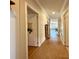 Inviting hallway with neutral walls and flooring leads to a sunlit living area at 272 S Port Royal Ln, Apollo Beach, FL 33572
