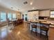 Bright open kitchen and dining area featuring a central island and lots of windows at 272 S Port Royal Ln, Apollo Beach, FL 33572