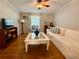 Comfortable living room featuring hardwood floors, a ceiling fan, and nice furniture at 272 S Port Royal Ln, Apollo Beach, FL 33572