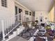 Inviting covered porch with comfortable seating and a decorative rug, perfect for relaxing at 272 S Port Royal Ln, Apollo Beach, FL 33572