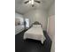 Bright bedroom featuring dark wood floors, vaulted ceiling, and a ceiling fan at 28549 Seashell Ct, Wesley Chapel, FL 33545