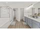 Bright bathroom features a double vanity, spacious shower, separate toilet room, and wood-look floors at 2944 Billingham Dr, Land O Lakes, FL 34639