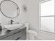 Stylish half bathroom featuring a modern vanity, round mirror and sleek fixtures at 2944 Billingham Dr, Land O Lakes, FL 34639