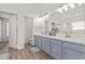 Well-lit bathroom features double sinks, modern lighting, a large mirror, and a separate room for the toilet at 2944 Billingham Dr, Land O Lakes, FL 34639