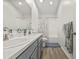 Bathroom featuring double sinks, white countertops, and a tub with shower at 2944 Billingham Dr, Land O Lakes, FL 34639
