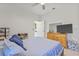 Bedroom with tiled floors, ceiling fan, and a dresser with a TV on top at 2944 Billingham Dr, Land O Lakes, FL 34639
