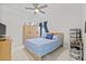 Cozy bedroom with tiled floors, ceiling fan, and a window for natural light at 2944 Billingham Dr, Land O Lakes, FL 34639