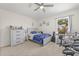 Bright bedroom with music-themed decor, a ceiling fan, and a view of the outdoors at 2944 Billingham Dr, Land O Lakes, FL 34639