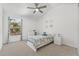 Bright bedroom with ample light from the large window and ceiling fan at 2944 Billingham Dr, Land O Lakes, FL 34639