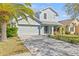 Charming two-story home with a well-manicured lawn, large driveway, and a two-car garage at 2944 Billingham Dr, Land O Lakes, FL 34639