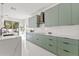 Modern kitchen boasts ample countertop space, streamlined cabinets, designer backsplash, and lots of natural light at 2944 Billingham Dr, Land O Lakes, FL 34639