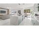 Open kitchen featuring a large center island, stainless steel appliances, and ample cabinet space, merging to living area at 2944 Billingham Dr, Land O Lakes, FL 34639