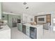 Bright open-concept kitchen featuring stainless steel appliances, modern cabinets, island with beverage cooler, and seamless connection to the living area at 2944 Billingham Dr, Land O Lakes, FL 34639