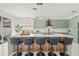 Stylish kitchen island with bar seating, sleek countertops, modern lighting, and cabinets offers a perfect spot for casual dining and entertaining at 2944 Billingham Dr, Land O Lakes, FL 34639