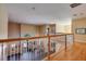 Open hallway with wood floors and white railings overlooking the floor below at 3030 Cedar Trce, Tarpon Springs, FL 34688