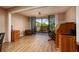 Inviting living room featuring wood floors, a rolltop desk, and sliding glass doors to a screened-in balcony at 3062 Eastland Blvd # 402, Clearwater, FL 33761