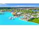 Picturesque aerial view of a lagoon with clear blue water and white sandy beaches in a vibrant neighborhood at 30753 Penny Surf Loop, Wesley Chapel, FL 33545