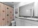 Bathroom with double sinks, granite countertops, and a whimsical shower curtain with mushroom accents at 30753 Penny Surf Loop, Wesley Chapel, FL 33545