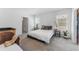 Bright bedroom features a queen bed, two windows, and a closet at 30753 Penny Surf Loop, Wesley Chapel, FL 33545