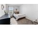 Cozy bedroom with soft textures, chair, and a sunny window that invites an abundance of natural light at 30753 Penny Surf Loop, Wesley Chapel, FL 33545