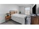 Bedroom features a queen bed with stylish headboard, side table, and natural light from the window at 30753 Penny Surf Loop, Wesley Chapel, FL 33545