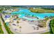 Gorgeous white sand community beach with palm trees, lagoon, and beach loungers at 30753 Penny Surf Loop, Wesley Chapel, FL 33545