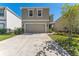 Two-story home showcasing a neutral color scheme, well-kept lawn, and a spacious two-car garage at 30753 Penny Surf Loop, Wesley Chapel, FL 33545