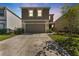 Two-story home showcasing a neutral color scheme, well-kept lawn, and a spacious two-car garage at 30753 Penny Surf Loop, Wesley Chapel, FL 33545