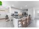 Modern kitchen featuring white cabinets, granite countertops, and a breakfast bar with seating at 30753 Penny Surf Loop, Wesley Chapel, FL 33545