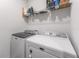 Laundry room equipped with a Maytag washer and dryer set, and shelving for storage solutions at 30753 Penny Surf Loop, Wesley Chapel, FL 33545