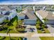 Aerial view of a charming single-Gathering home featuring a well-manicured lawn and beautiful palm trees at 318 Blackrock Ln, Apollo Beach, FL 33572
