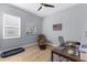 Inviting bedroom featuring a desk, a ceiling fan, a recliner and a comfortable space for relaxing or working from home at 318 Blackrock Ln, Apollo Beach, FL 33572