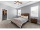 Serene bedroom featuring a tray ceiling, a wooden bed frame, and a walk-in closet for ample storage at 318 Blackrock Ln, Apollo Beach, FL 33572