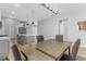 Dining room with modern lighting and hardwood floors, adjacent to the kitchen and living spaces at 318 Blackrock Ln, Apollo Beach, FL 33572