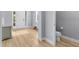 Bright foyer with a bench and a view of the WC with an updated commode at 318 Blackrock Ln, Apollo Beach, FL 33572